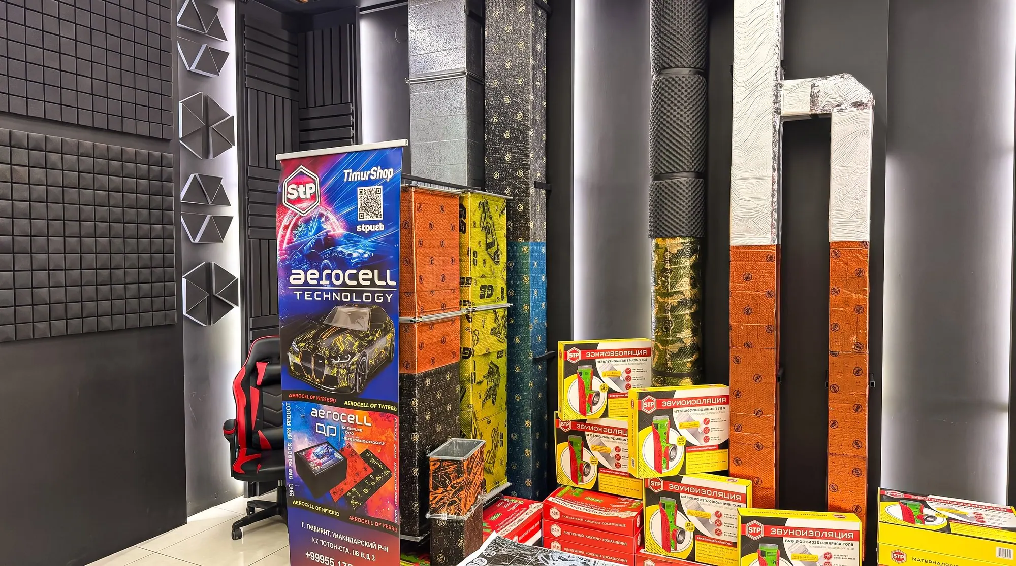StP Aerocell display stand beside acoustic panels and boxed material